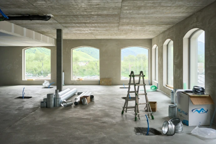 A large room with windows and a ladder